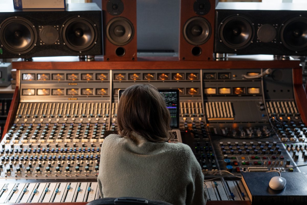 Audio engineer Dani Bennett Spragg sitting in from of a mixing console