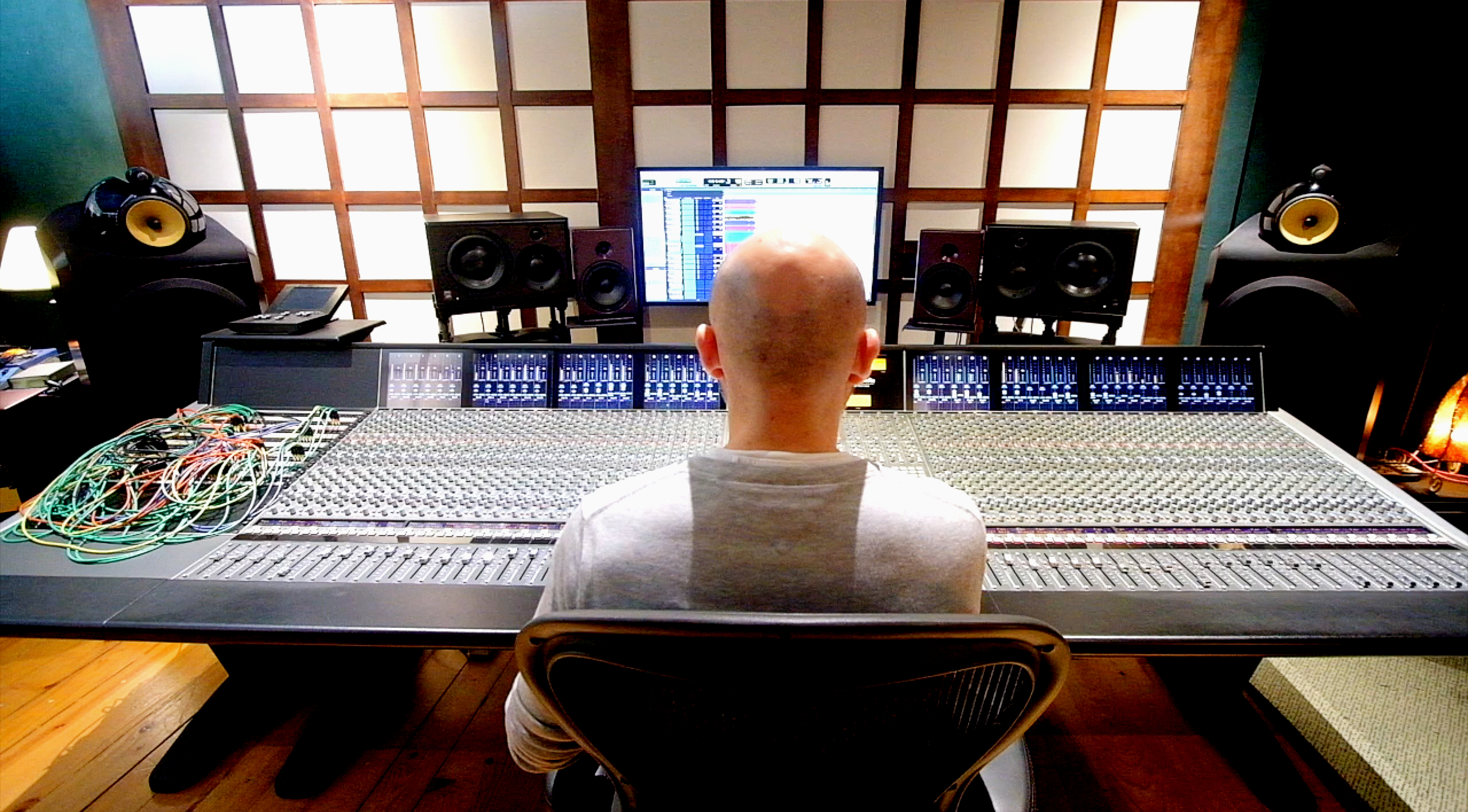 A man sitting in front of a mixing console